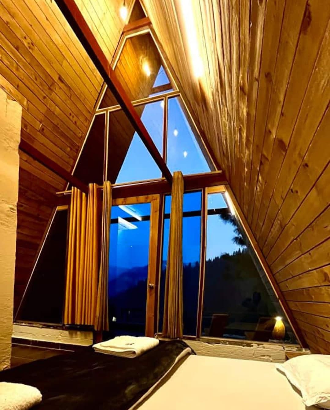 Cozy wooden interior of A-frame cottage in Jibhi