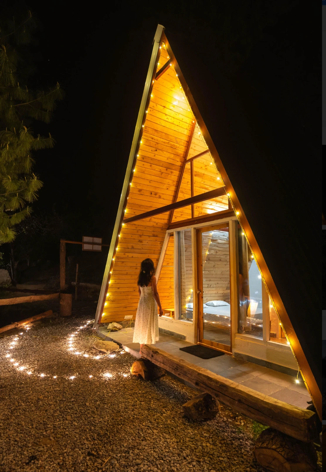 A-frame cottage at Nirvana Tandi Jibhi illuminated at night